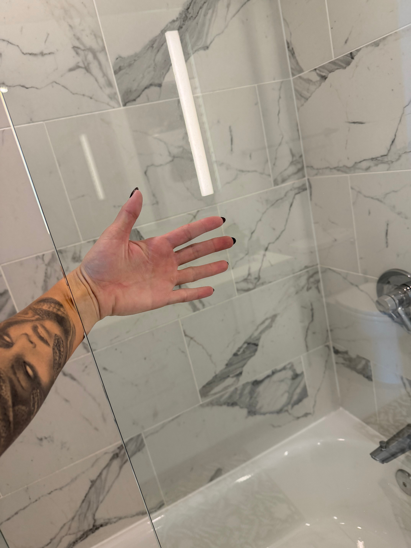 Streak-free shower glass and marble tile after a Magic Clean Miami deep cleaning