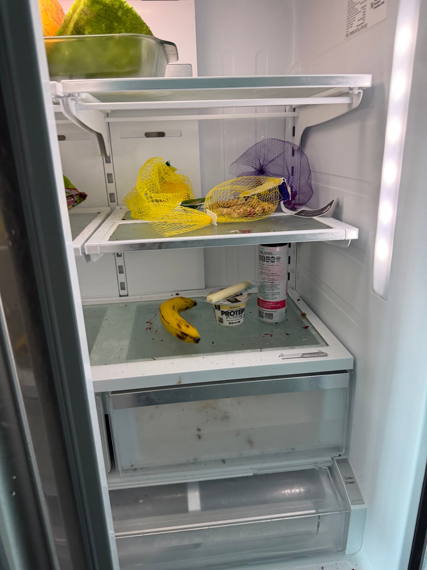 Messy refrigerator interior with spills before a deep cleaning